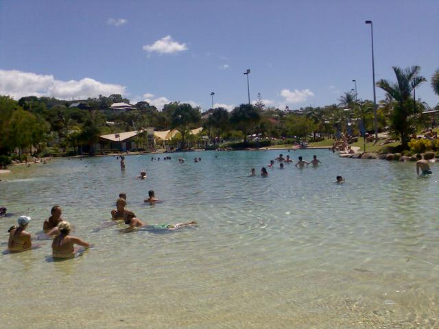 Travellers and locals relax at Airlie Beach's lagoon