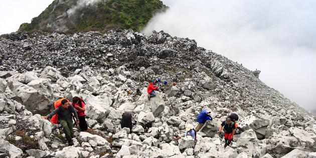 Hikers climbing along craggy rockscapes