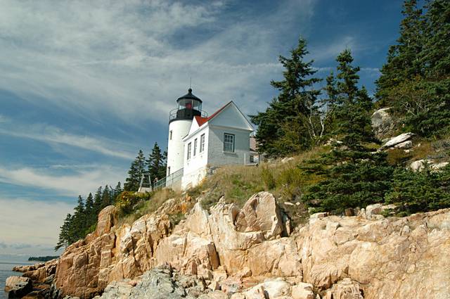 A dramatic lighthouse in repose atop Acadia's rocky shoreline