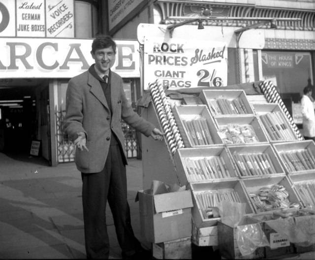 A man sells Blackpool rock from his stand in 1959. Prices may no longer be accurate.