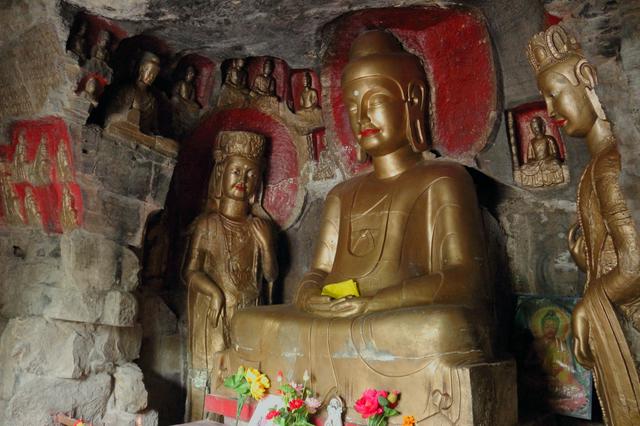 Carved and painted Buddhas at Qianfo Mountain Scenic Spot.