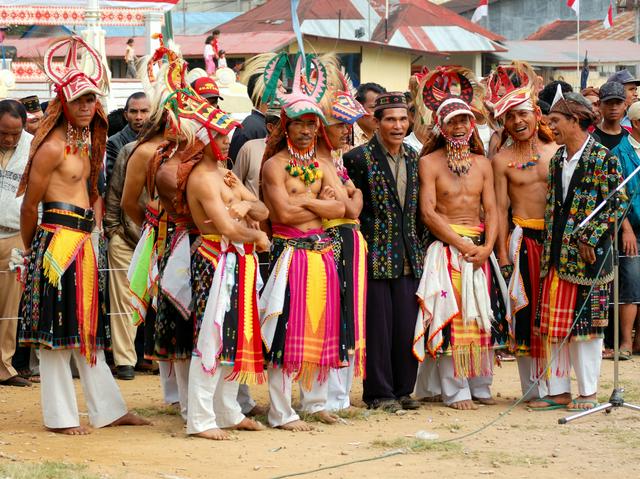 Caci warrior/dancers getting ready to perform their war dance for an outdoor audience in Ruteng