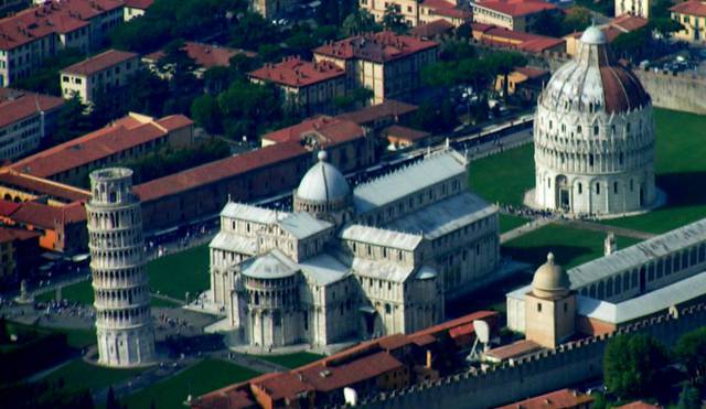 The Campo dei Miracoli from above: The leaning tower is on the left, the Duomo is in the centre, the Baptistery is on the right, and part of the Camposanto is in the right foreground