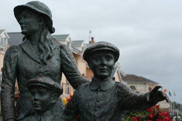 Sculpture by Jeanne Rynhart of Annie Moore and her brothers. The sculpture broadly represents the Irish emigration experience. It assumes a place of prominence on the waterfront as Cobh was a significant port of departure for the Irish.