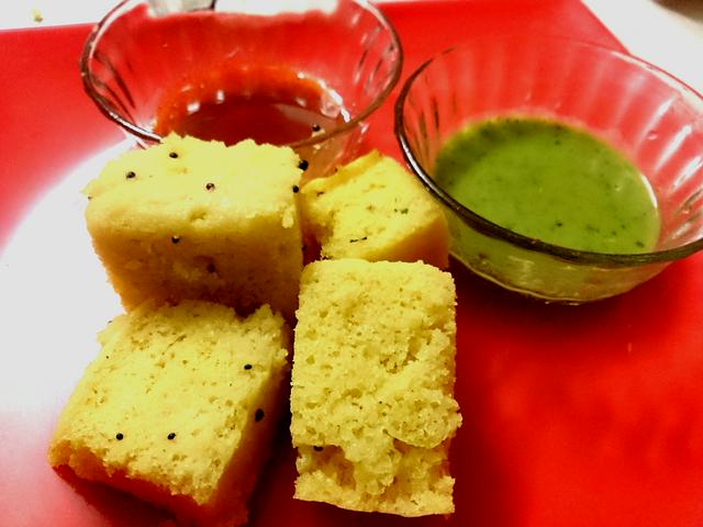 Dhokla is a sweet made of fermented rice and chickpea batter served with tamarind and green chilli chutney.