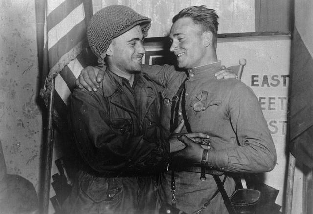 2nd Lieutenant Robertson (US Army) and Lieutenant Silvashko (Soviet Red Army) celebrating their meeting near Torgau in April 1945