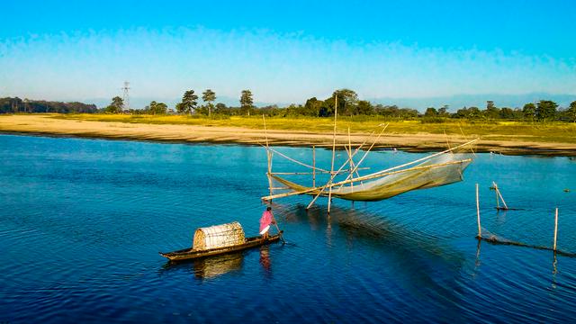 A fisherman out to catch fish next to Majuli.