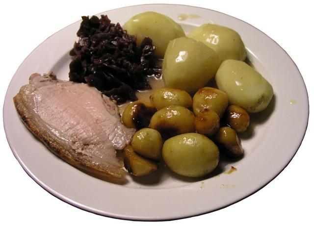 Flæskesteg (pork roast with cracklings) with potatoes, brown gravy and pickled red cabbage. Traditional Danish food are often hearty meals and pairs well with beer.