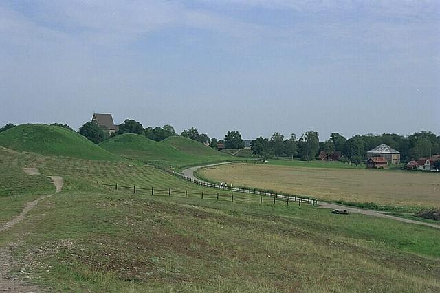 Old Uppsala burial mounds, with the church visible in the background and the museum visible to the right.