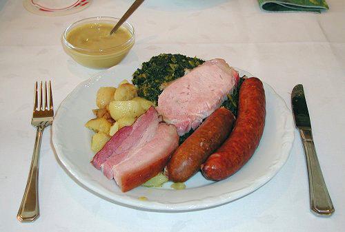 Grünkohlessen, a typical regional dish: kale served with Pinkel, Kochwurst, Kassler and bacon