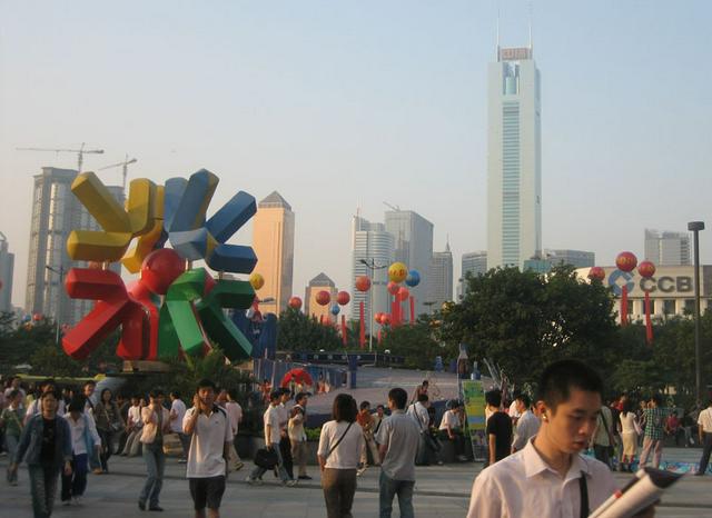 Locals on the run outside the Grandview Plaza in Tianhe District. In the background is the 80-story CITIC Plaza.