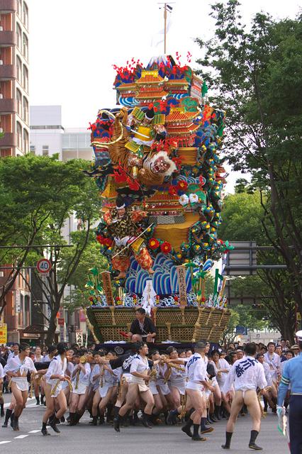 Yamakasa participants carry one of the participating floats