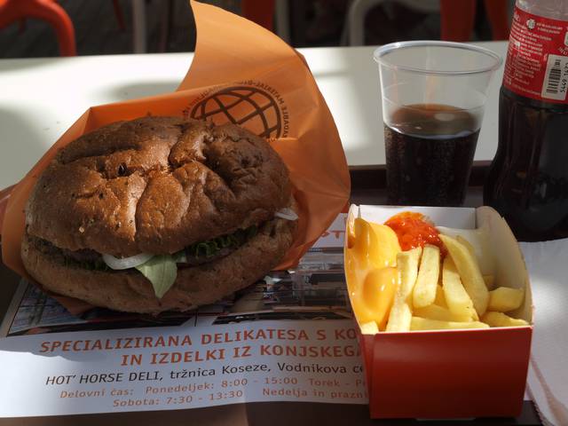 A horse meat hamburger along with French fries and a cup of Coca-Cola, served at restaurant Hot' Horse in the Tivoli Park northwest of the centre of Ljubljana.