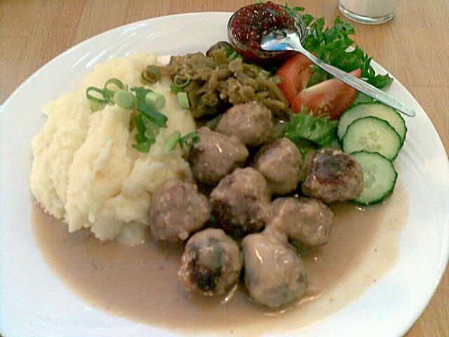 Meatballs (lihapullat), served with mashed potatoes, creamy roux sauce, salad and lingonberry jam