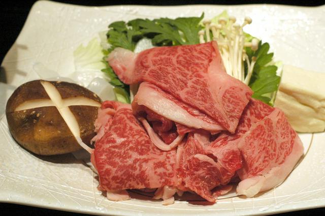 Thinly sliced well-marbled Yonezawa beef, about to be cooked as sukiyaki