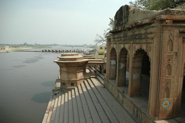 Kesi Ghat and the Yamuna River. The word "Radha" is repeatedly written on the side in the Devanagari alphabet.