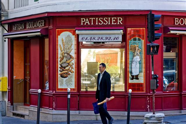 Bakery and customer with baguette