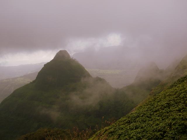 The mountain that appears like shivlinga just before hiding behind the dark clouds