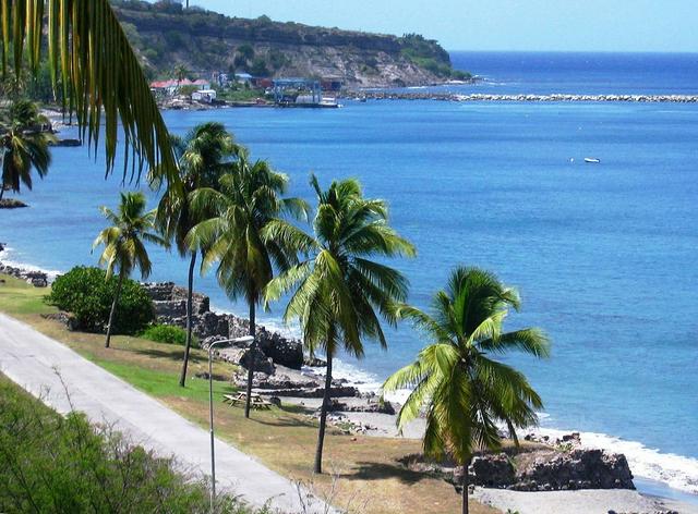 Part of the road through Lower Town on the Caribbean coast, showing the ruins of 18th century warehouses on the shore