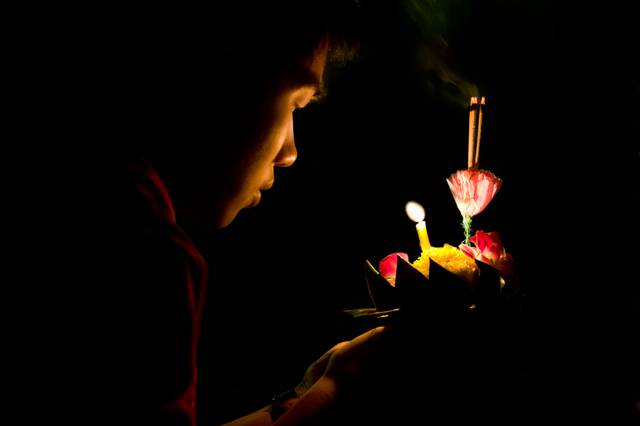 Launching a krathong down a pond