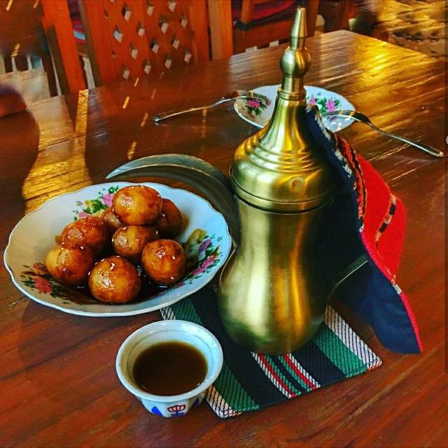 Arabic coffee served with traditional Emirati sweets called Lugaimat.