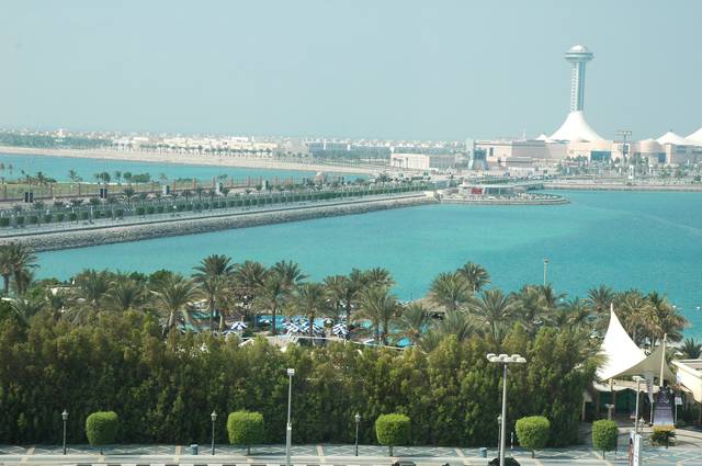 The turquoise waters surrounding Abu Dhabi islands along the Corniche, with the Marina Mall in the background