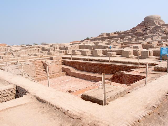 Excavated ruins, with the Great Bath in the foreground and the Buddhist Stupa in the background