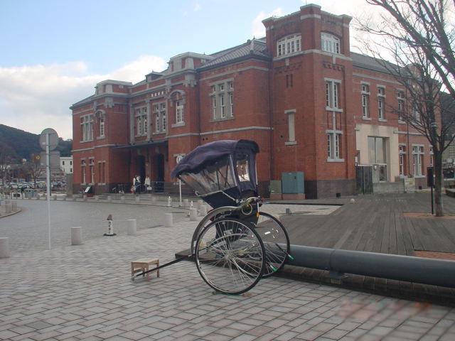 The old Moji customs building and rickshaw for hire