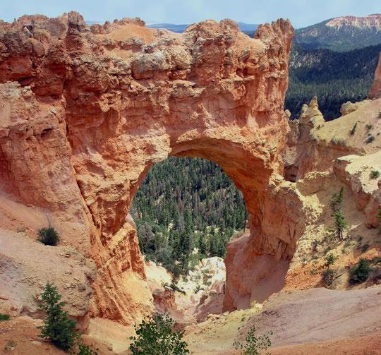 Bryce Canyon is 60 miles from Mount Carmel Junction and after visiting Zion National Park many head over to Bryce. The photo is Natural Bridge in Bryce Canyon