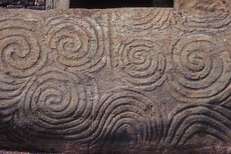 The entrance slab is 10 feet by 4 feet in size and 5 tons in weight. It is one of the most famous rocks in Ireland and stands at the entrance to Newgrange, a “passage tomb” 300 feet in diameter and 40 feet high that is older than the Egyptian pyramids and Stonehenge. The carved spiral design, although more ancient than the coming of the Celts to Ireland, was often copied by them and became one of the legendary Celtic designs.