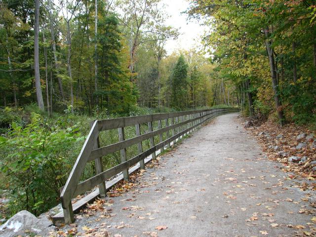 A portion of the Ohio and Erie Canal Tow-Path Trail. The Cuyahoga River used to run to the immediate left of the shown path, but has been directed via dam to run further to the left behind the trees.