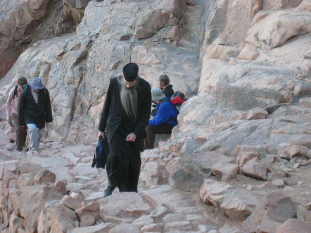 Orthodox priest walking up Mount Sinai