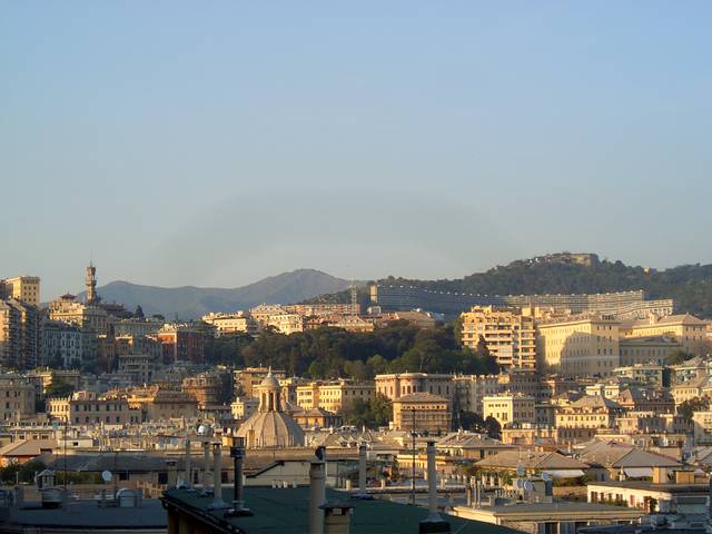The romantic port of Genoa, with its lovely seaside buildings and wooded rolling hills.