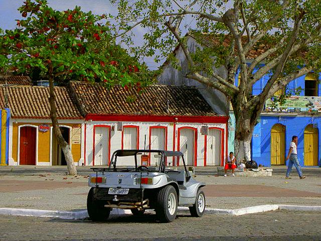 Colourful colonial era homes along the port street & the typical rent-a-car for the region.