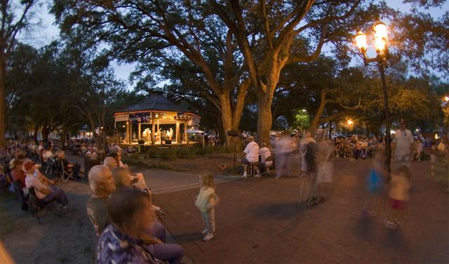A band plays underneath the oaks at Evenings in Olde Seville Square.