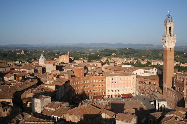 View of the oval-shaped Piazza del Campo, city and countryside beyond