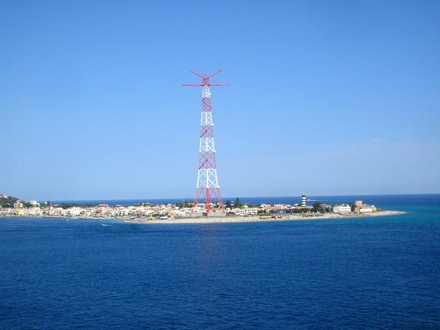 Pylon of Torre Faro overshadows the Capo Peloro lighthouse (right)