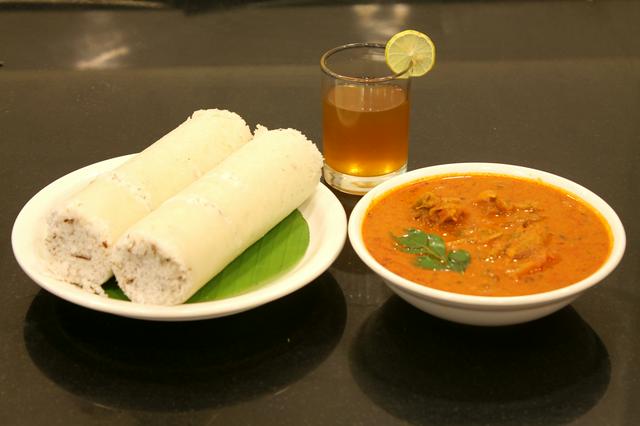 Puttu or steamed rice cakes is served with fish curry in North Paravur