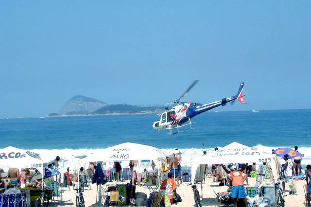 On weekends, beaches in Rio are watched by helicopters.