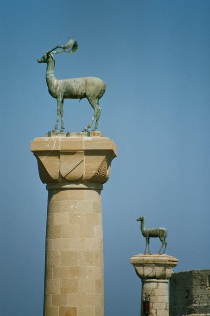 Modern bronze deer statues in Mandraki harbor, where the Colossus of Rhodes may have stood