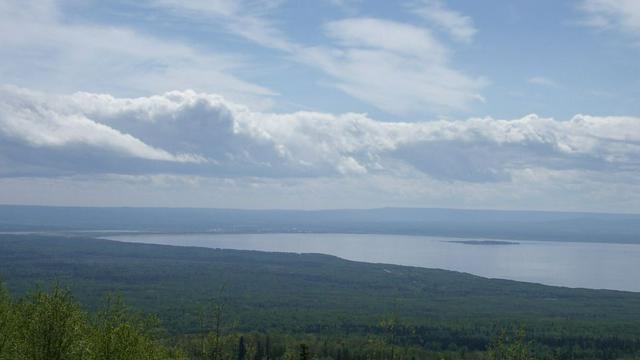 Lesser Slave Lake, as seen from Martin Mountain, with the town of Slave Lake, with the town of Slave Lake near the middle of the picture on the far shore