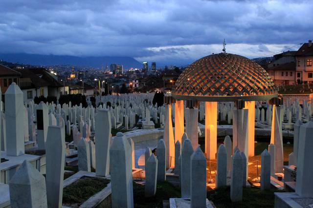 Alija Izetbegović tomb in the Kovači Memorial Cemetery at dusk.