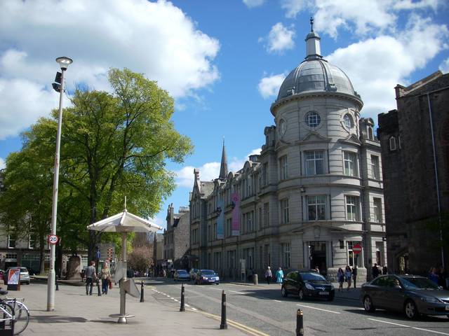 Granite buildings at Schoolhill, Aberdeen. Domed building in foreground was constructed in 1901 as the Aberdeen Academy school; today it houses the Academy Shopping Centre, with Jack Wills clothing store under the dome.