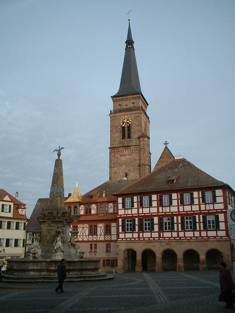 Town Hall and Beautiful Fountain in König Square. Town Church Clock Tower in the background