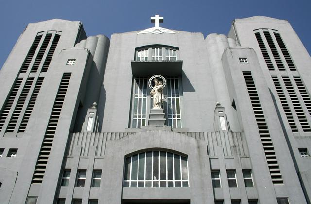 The facade of the cathedral with the statue of Mary Help of Christians