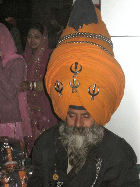 Sikh khandas displayed prominently on an exaggerated turban