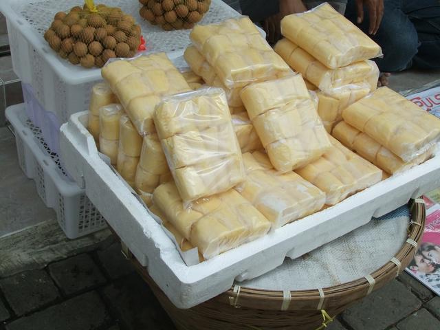 Cassava tapai is shown in plastic bags in the foreground