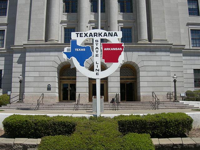 The state line sign in front of the post office and courthouse.