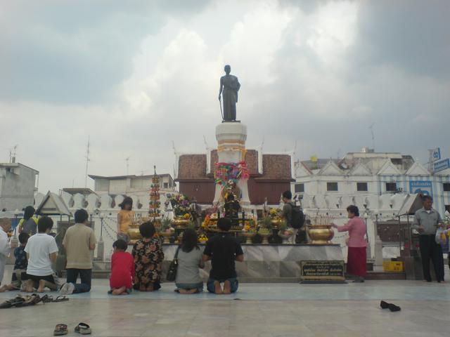 Locals kneel and pray in front of Yamo