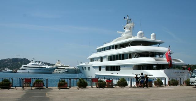 Three luxury yachts—Lady Anne, Lady Moura, and Pelorus, within the port of Porto Cervo